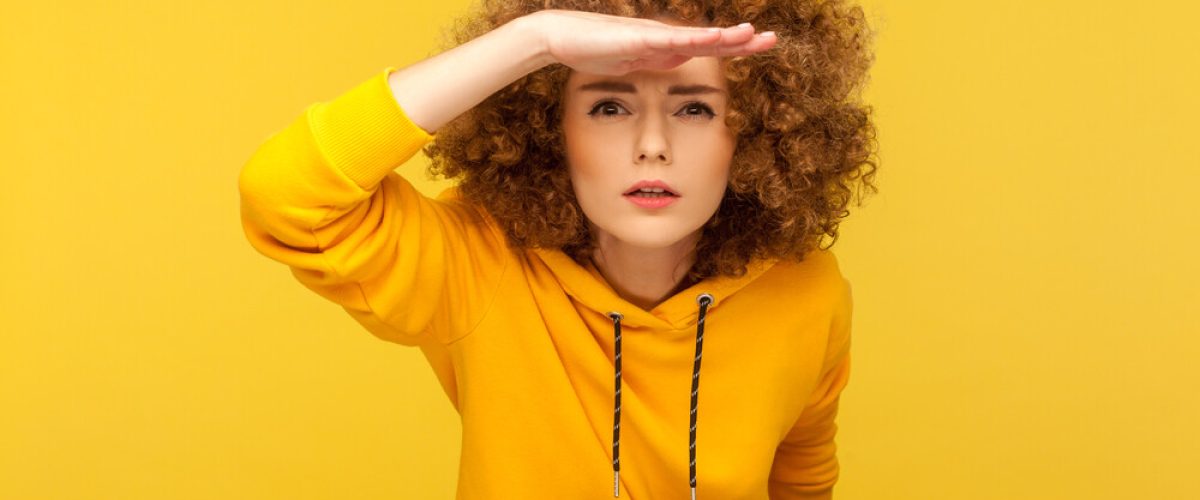 Portrait,Of,Curious,Curly-haired,Woman,In,Urban,Style,Hoodie,Holding