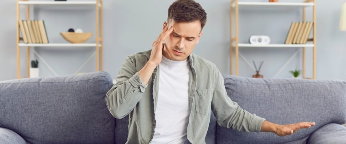 Unhealthy,Man,Suffering,From,Migraines,Or,Dizziness,Sits,On,The